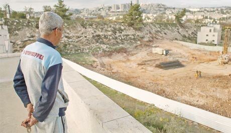 Beit Safafa resident observing highway construction