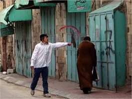 Settler throws wine at a Palestinian woman - Israeli Occupation Archive - israeli-occupation.org