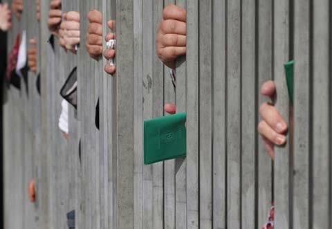 Palestinian women in West Bank city of Bethlehem wait to pass a checkpoint on their way to Jerusalem's Haram al-Sharif, September 2009. (Luay Sababa/MaanImages)