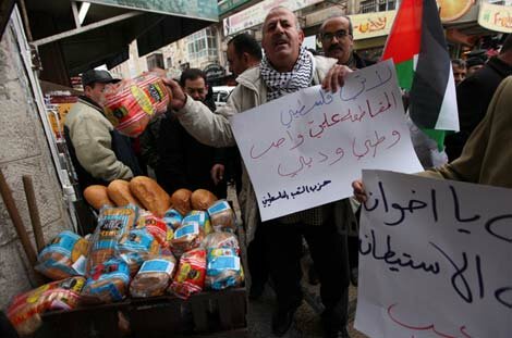 A Palestinian activist holds Israeli products sold in Ramallah